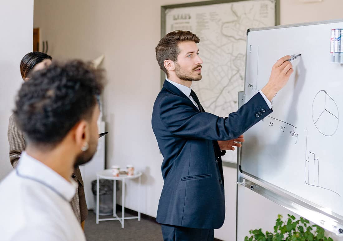 Man Drawing on Whiteboard Man Drawing on Whiteboard